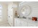 Clean bathroom with a white vanity, shiplap walls, and a round mirror for a modern touch at 2408 Bending Oak Loop, Mount Pleasant, SC 29466