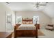 Cozy bedroom featuring wood bed frame, ceiling fan, and two windows, creating a bright and airy space at 2408 Bending Oak Loop, Mount Pleasant, SC 29466