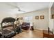 Bonus room with exercise equipment, comfortable leather sofa, ceiling fan, and wood floors at 2408 Bending Oak Loop, Mount Pleasant, SC 29466