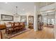 Dining room featuring stylish chandelier, patterned wallpaper, and hardwood floors flowing into the living space at 2408 Bending Oak Loop, Mount Pleasant, SC 29466