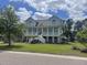 Stunning two-story home with a charming front porch, inviting curb appeal and a well-manicured lawn at 2408 Bending Oak Loop, Mount Pleasant, SC 29466