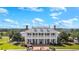 Grand clubhouse exterior with stately columns, manicured landscaping, and golf carts ready for play at 2408 Bending Oak Loop, Mount Pleasant, SC 29466