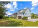 Charming light blue two-story home featuring a screened porch, spacious backyard, and driveway with garage at 2408 Bending Oak Loop, Mount Pleasant, SC 29466