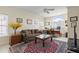 Comfortable living room with large windows, ceiling fan, floral sofa, and a work space at 2408 Bending Oak Loop, Mount Pleasant, SC 29466