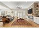 Spacious living room with a brick fireplace, hardwood floors, and large windows for natural light at 2408 Bending Oak Loop, Mount Pleasant, SC 29466