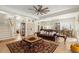 Open-concept living room with hardwood floors, a ceiling fan, and a seamless flow to the kitchen at 2408 Bending Oak Loop, Mount Pleasant, SC 29466