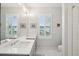 Bright bathroom featuring double sinks, white cabinets, and a large mirror at 2815 Colonel Harrison Dr, Johns Island, SC 29455