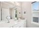 Bright bathroom with a large mirror, white vanity, and natural light from the window at 2815 Colonel Harrison Dr, Johns Island, SC 29455