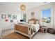 Bright bedroom with a cozy bed, desk area, natural light, and stylish decor at 2815 Colonel Harrison Dr, Johns Island, SC 29455