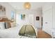 Well-lit bedroom featuring a cozy bed, adjoining bathroom, walk-in closet, and artwork at 2815 Colonel Harrison Dr, Johns Island, SC 29455