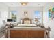Spacious bedroom with two windows, stylish decor, and a cozy work area at 2815 Colonel Harrison Dr, Johns Island, SC 29455