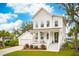 Charming two-story home with white siding, a inviting front porch and a detached garage at 2815 Colonel Harrison Dr, Johns Island, SC 29455