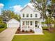 Charming two-story home with white siding, a inviting front porch and a detached garage at 2815 Colonel Harrison Dr, Johns Island, SC 29455