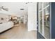 Sunlit foyer with wood floors, flowing into an open-concept living space and modern kitchen at 2815 Colonel Harrison Dr, Johns Island, SC 29455