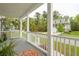 Inviting front porch view, complete with stylish railings and lush, green surroundings at 2815 Colonel Harrison Dr, Johns Island, SC 29455