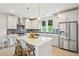 Bright kitchen featuring stainless steel appliances, an island with bar seating, and white cabinets at 2815 Colonel Harrison Dr, Johns Island, SC 29455