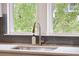 Bright kitchen sink with gooseneck faucet sits in front of a window overlooking greenery at 2815 Colonel Harrison Dr, Johns Island, SC 29455