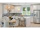Open kitchen with stainless steel appliances, white cabinets, bar stool seating, and eat-in dining table at 2815 Colonel Harrison Dr, Johns Island, SC 29455