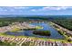 Expansive aerial view of a lakefront neighborhood with charming homes, walking paths, and verdant trees at 2866 Sugarberry Ln, Johns Island, SC 29455