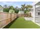 A fenced backyard with artificial grass and access to a screened-in porch at 2866 Sugarberry Ln, Johns Island, SC 29455