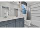 Bright bathroom featuring double vanity, tiled floors, and a shower-tub combo with tiled surround at 2866 Sugarberry Ln, Johns Island, SC 29455