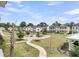 A beautiful community park with walkways, trees, grass, picnic tables, and several colorful homes at 2866 Sugarberry Ln, Johns Island, SC 29455
