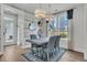 Bright dining room featuring modern lighting, wood floors, and elegant blue accents at 2866 Sugarberry Ln, Johns Island, SC 29455