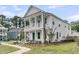 Corner-lot home featuring a double-decker porch and green surroundings at 2866 Sugarberry Ln, Johns Island, SC 29455