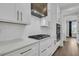 Kitchen boasts white cabinetry, quartz countertops, and a gas range at 2866 Sugarberry Ln, Johns Island, SC 29455