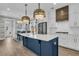 Modern kitchen with a large island, stainless steel appliances, and stylish pendant lights at 2866 Sugarberry Ln, Johns Island, SC 29455
