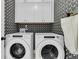Charming laundry room featuring modern appliances and stylish crane-patterned wallpaper at 2866 Sugarberry Ln, Johns Island, SC 29455