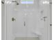Contemporary all-white tiled walk-in shower with a glass enclosure and bench seating at 2866 Sugarberry Ln, Johns Island, SC 29455