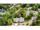 An aerial view shows an apartment complex surrounded by lush trees and a pond at 308 Pickering Ln, Charleston, SC 29414