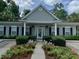 A clubhouse exterior view showcases the property's welcoming entrance and landscaping at 308 Pickering Ln, Charleston, SC 29414