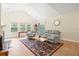 Bright living room with vaulted ceiling, light floors, fireplace, and lots of natural light at 308 Pickering Ln, Charleston, SC 29414