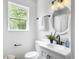 Bright bathroom with white vanity, matte black fixtures, and decorative fern at 3105 Matipan Ave, North Charleston, SC 29405
