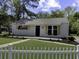 Charming home featuring a well-manicured lawn, flower boxes under the windows, and white picket fence at 3105 Matipan Ave, North Charleston, SC 29405