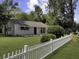 Charming home featuring a well-manicured lawn, flower boxes under the windows, and white picket fence at 3105 Matipan Ave, North Charleston, SC 29405