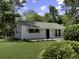 Charming home featuring a well-manicured lawn, flower boxes under the windows, and mature landscaping at 3105 Matipan Ave, North Charleston, SC 29405