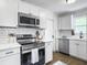Bright kitchen features stainless steel appliances, white subway tile backsplash, and quartz countertops at 3105 Matipan Ave, North Charleston, SC 29405
