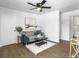 Cozy living room with modern furnishings, wood floors, a ceiling fan, and lots of natural light at 3105 Matipan Ave, North Charleston, SC 29405