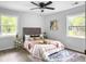 Light filled main bedroom with ceiling fan, stylish rug, and decorative pillows at 3105 Matipan Ave, North Charleston, SC 29405