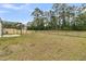 A large backyard, partially fenced, featuring a concrete patio area for outdoor gatherings and relaxation at 313 Squire Pope Rd, Summerville, SC 29486