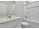 Full bathroom with white fixtures, including a tub, toilet, and vanity with a large mirror at 313 Squire Pope Rd, Summerville, SC 29486