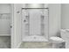 Bright bathroom featuring a clean white shower stall, toilet, and neutral wall and flooring at 313 Squire Pope Rd, Summerville, SC 29486