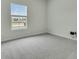 Spacious bedroom with neutral walls, carpet flooring, and a window offering natural light at 313 Squire Pope Rd, Summerville, SC 29486