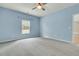 This blue empty bedroom offers space and natural light at 313 Squire Pope Rd, Summerville, SC 29486