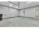An empty two car garage providing ample room for parking and storage with overhead lighting at 313 Squire Pope Rd, Summerville, SC 29486