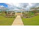 Community park with benches, landscaping, and walking path under a bright, cloudy sky at 313 Squire Pope Rd, Summerville, SC 29486