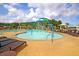 Community pool with splash pad, lounge chairs, umbrellas, and manicured landscaping at 313 Squire Pope Rd, Summerville, SC 29486